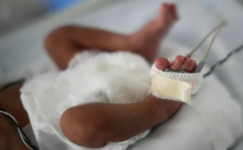[File Image]: New born baby laying in a crib.