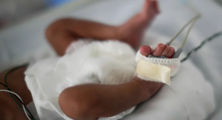 [File Image]: New born baby laying in a crib.