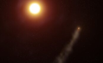 An alien planet trailing a long comet-like tail around red-orange star