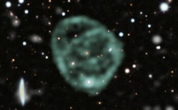 A strange blob of green circles around a galaxy in deep space
