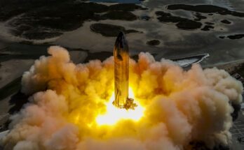 a rocket on a launch pad fires its engines, creating a massive plume of fire and smoke