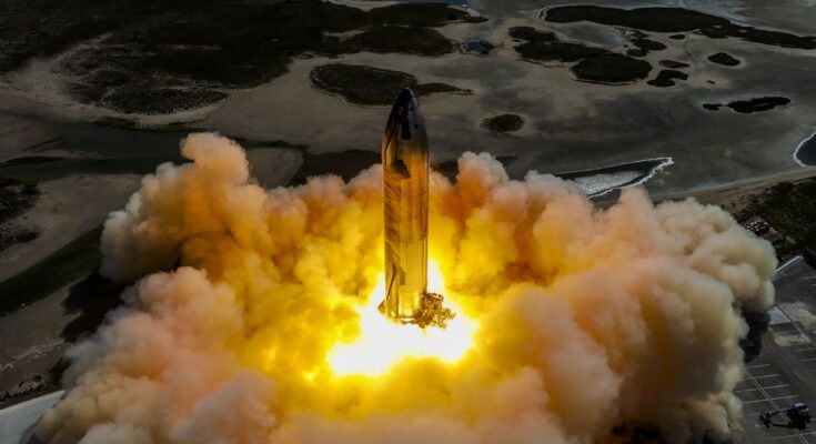 a rocket on a launch pad fires its engines, creating a massive plume of fire and smoke