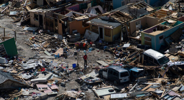 A man walks through debris in Marsh Harbour, Bahamas on Sept. 9, 2019 in the aftermath of Hurricane Dorian. Credit: Carolyn Van Houten/The Washington Post via Getty Images