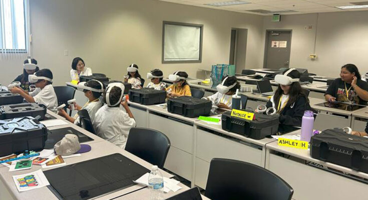 Students wearing VR headsets in a classroom.