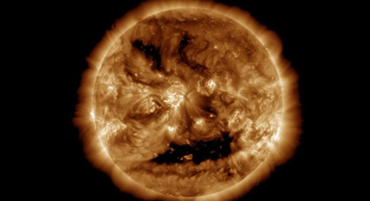spooky face on sun by NASA on Halloween cover