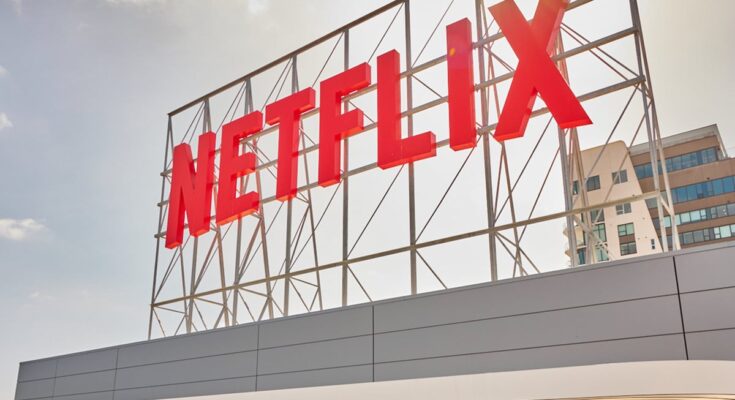 A Netflix sign on top of a building.