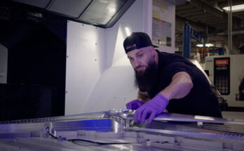 Experimental machinist Cory Pennington examines a freshly milled, full-scale Dragonfly rotor